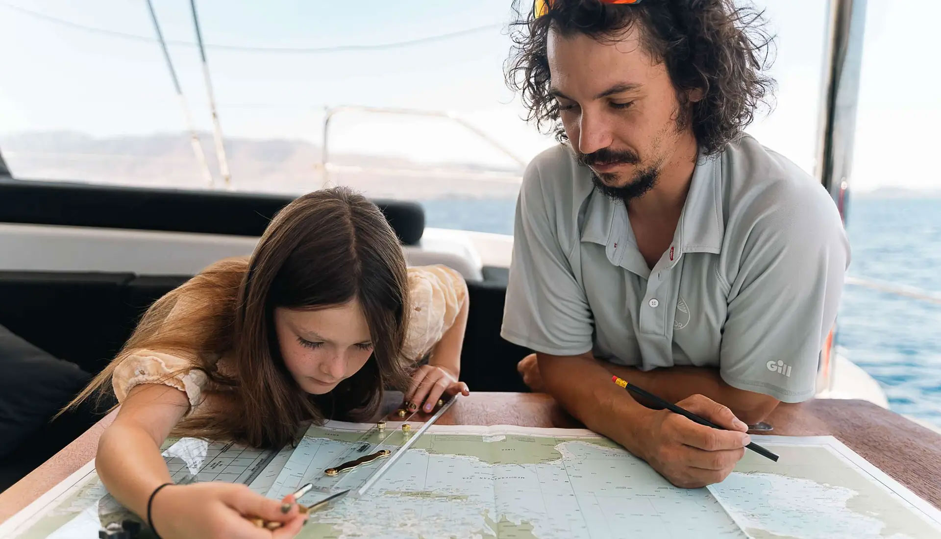 Licensed captain teaching guest navigation on yacht during captain-only charter