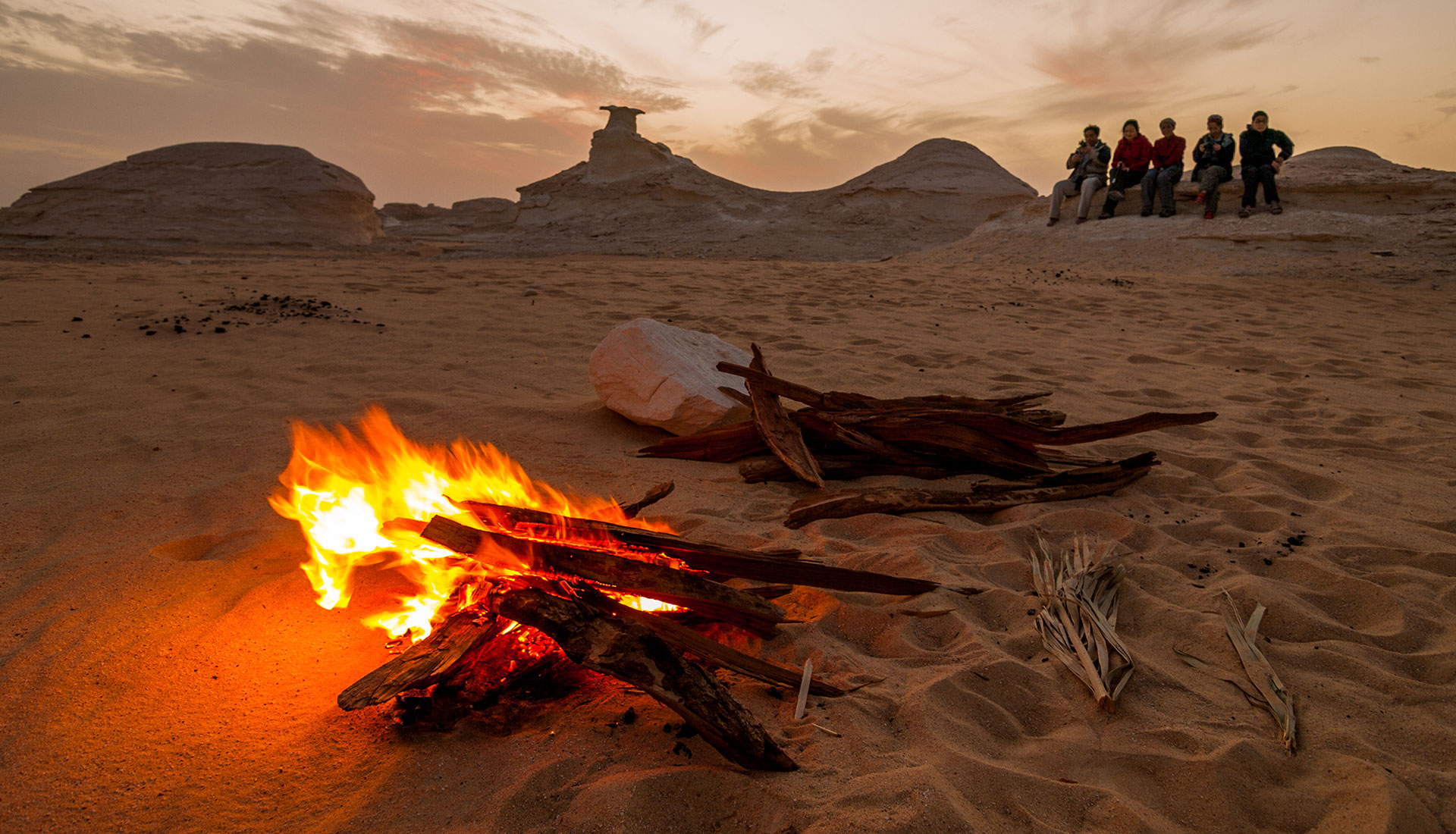 Desert bonfire at sunset Egypt Red Sea adventure experience with travelers gathered