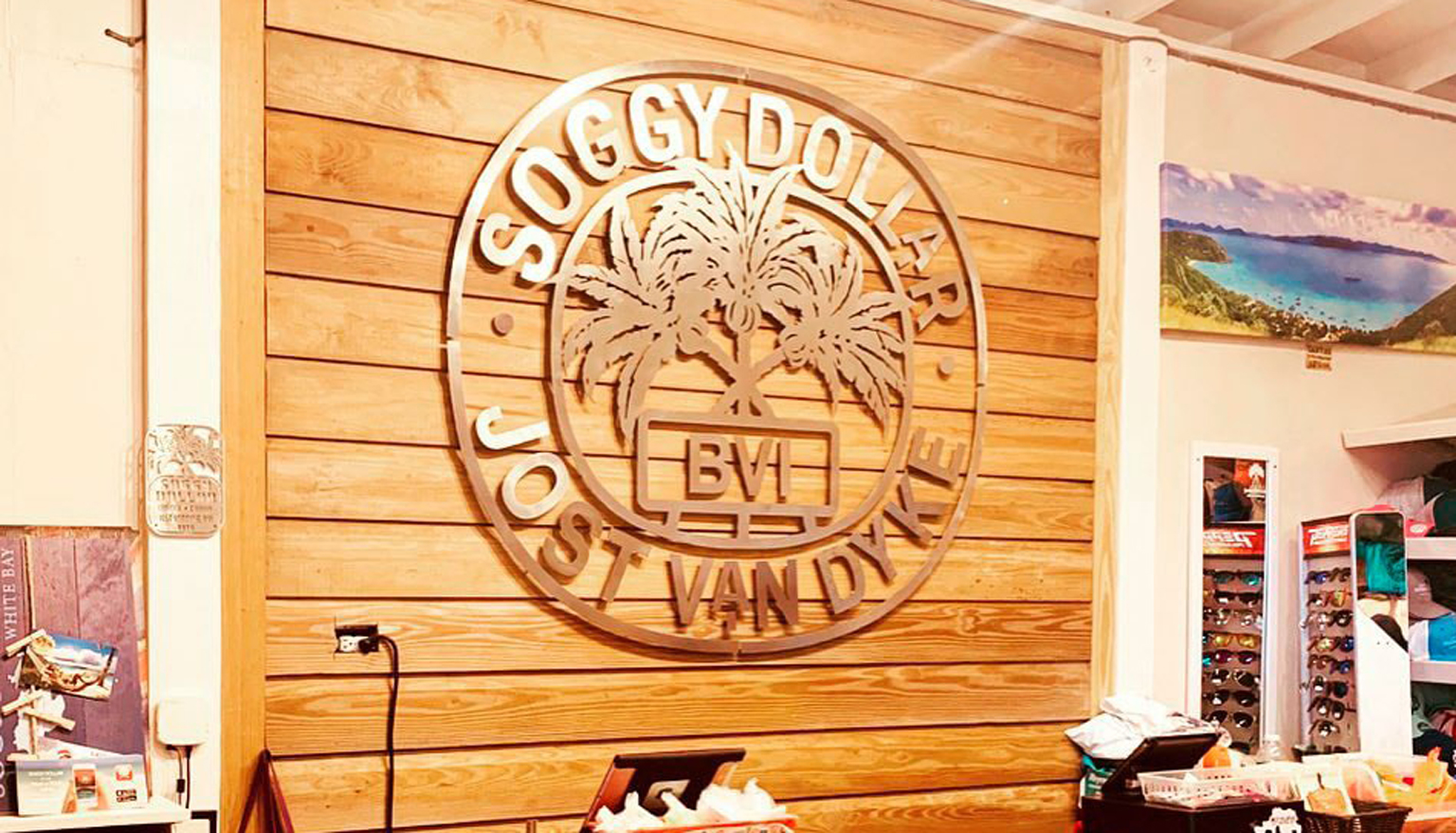 Soggy Dollar Bar interior with branded logo wall and rum kegs, White Bay, Jost Van Dyke BVI